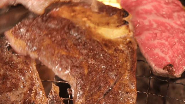 Juicy barbecue grilling over charcoal flames