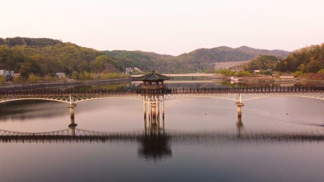 Scenic bridge over a calm river at sunset