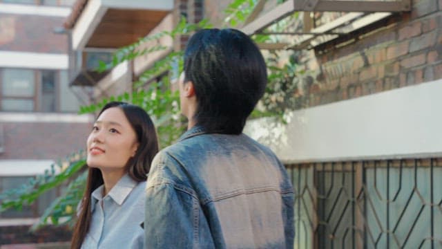 Couple looking up in a sunny alley