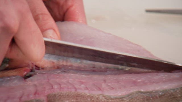Delicately filleting a fresh fish in the kitchen with a knife
