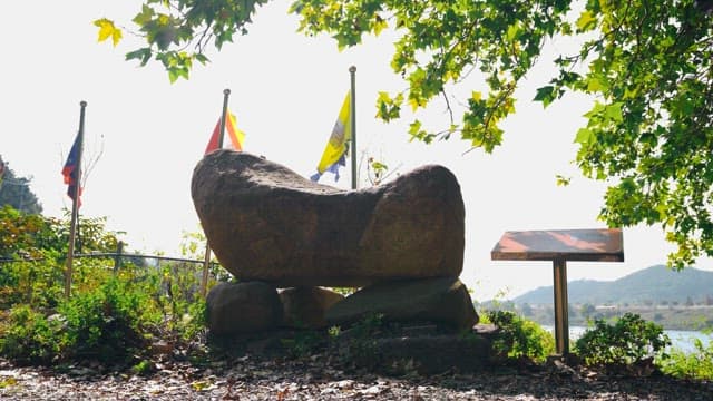 Rock tower surrounded by trees and greenery