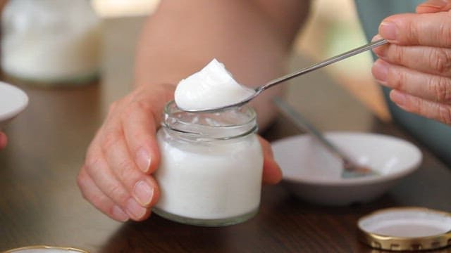 People enjoying milk pudding at a table