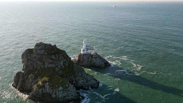Lighthouse on a rocky island in the sea