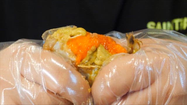 Hand with Plastic Gloves Deboning Soy Sauce Marinated Crab