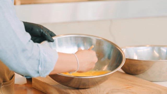 Stirring Eggs in a Mixing Bowl with Chopsticks