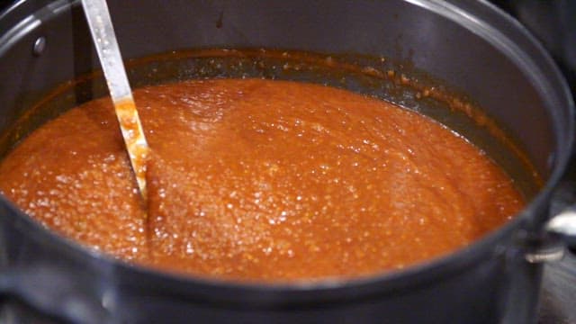 Rich sauce for pork cutlet being stirred in a pot