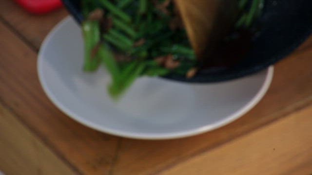 Stir-fried pork and young radish leaves served on a plate