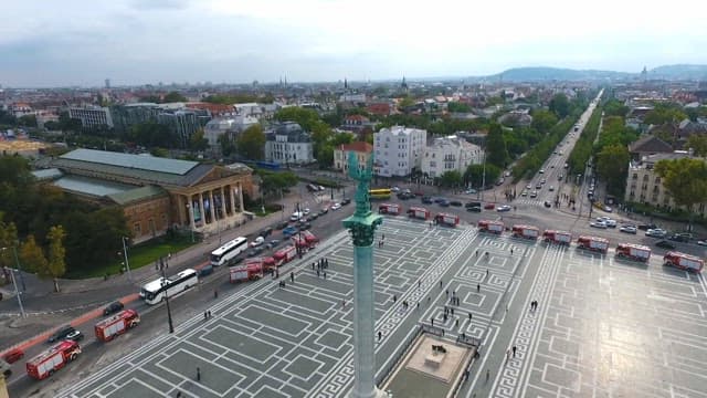 Statue overlooking a busy city street
