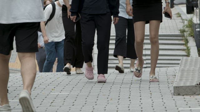 Urban Commuters Walking on Pavement