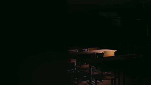 Dimly Lit Classroom with Empty Desks