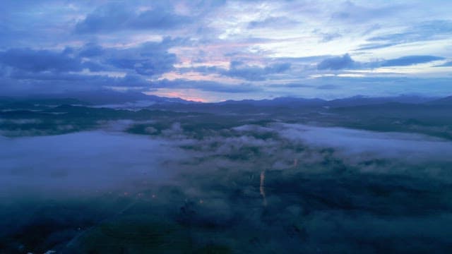 Misty mountains at dawn with a colorful sky