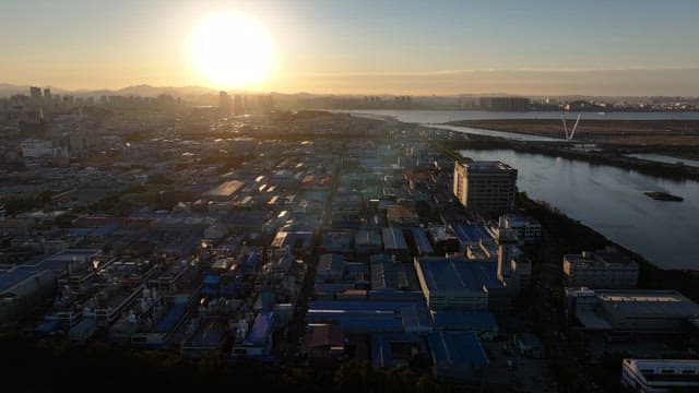Sunset Over Urban Landscape and Sea