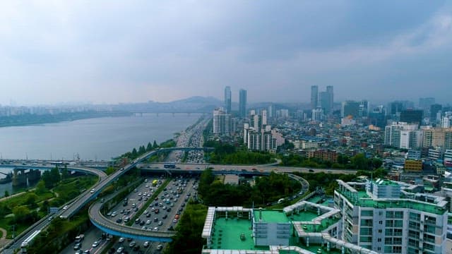 Busy Traffic with Cars on the Riverside in a City 