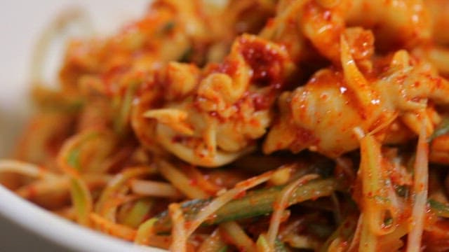 Spicy sea snails salad with green onions and dried monkfish