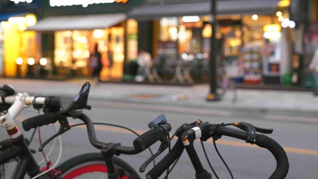 Bicycles parked on a busy street at dusk