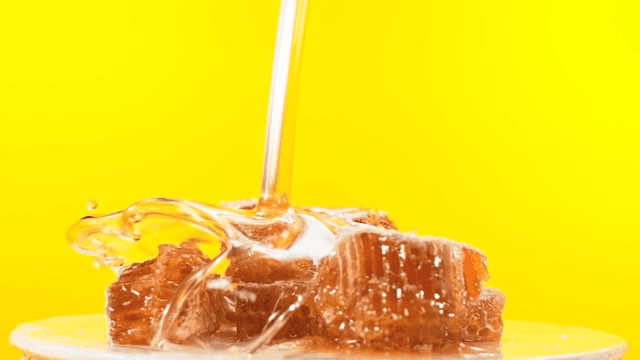 Honeycomb with honey pouring on top