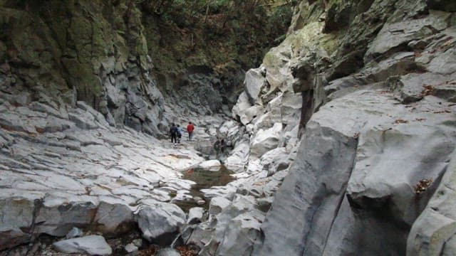 Hikers walking through a quiet and majestic rocky valley