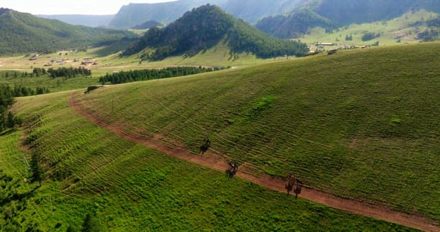 Expansive green valley with distant mountains