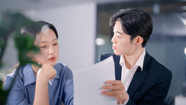 Two colleagues discussing documents