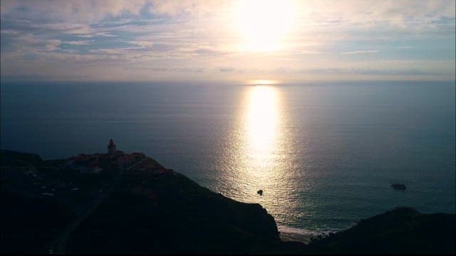 Coastal Lighthouse Overlooking the Sea at Sunset