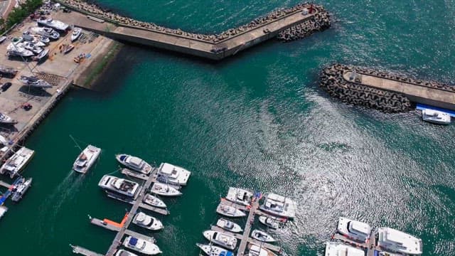 Yachts sailing near a peaceful marina