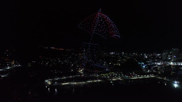 Nighttime Drone Light Show over Cityscape
