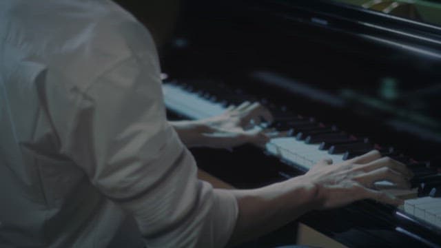 Pianist's Hands Waiting to Play the Piano