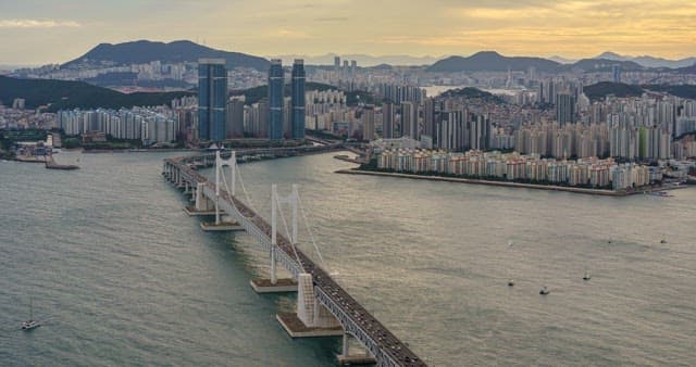 Busy traffic on Gwangan Bridge and evening scenery of the port city Busan