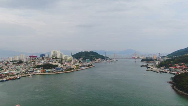 Coastal city with a bridge and mountains