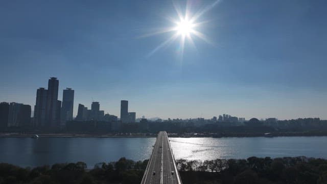 Sunlit Bridge Over Hangang River with Urban Skyline
