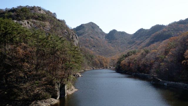 Serene autumn landscape with mountain and river