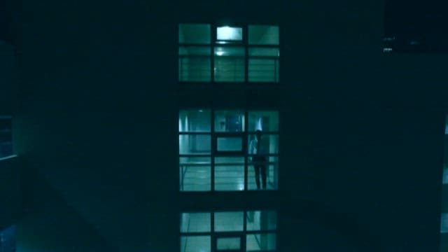 Exterior of a building with a view of the lit offices at night