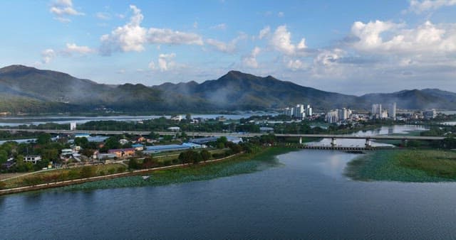 Scenic view of a village by the river