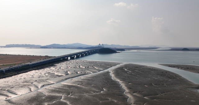 Long bridge over a serene coastal area