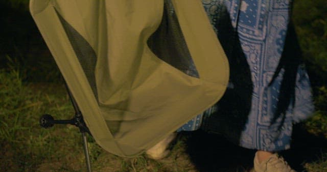 Woman Bringing a Camping Chair and Sitting by Her Friend