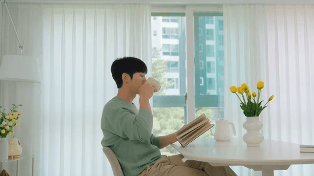 Man Reading a Book While Drinking Coffee