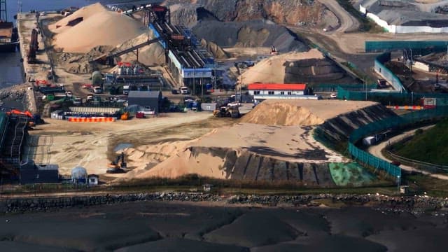 Construction site with sand piles and machinery