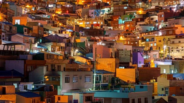 Vibrant Gamcheon Culture Village on a hill full of illuminated houses at night