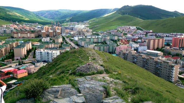 Cityscape with green hills in the background