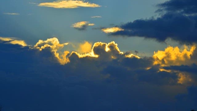 Golden Sunlight Shining Through Clouds