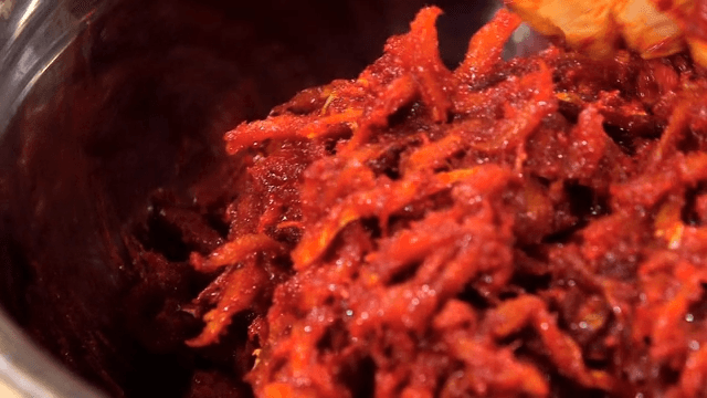 Mixing raw pollack seasoning with red pepper powder