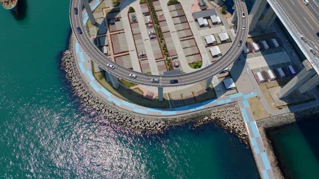 Aerial view of a circular highway over the ocean