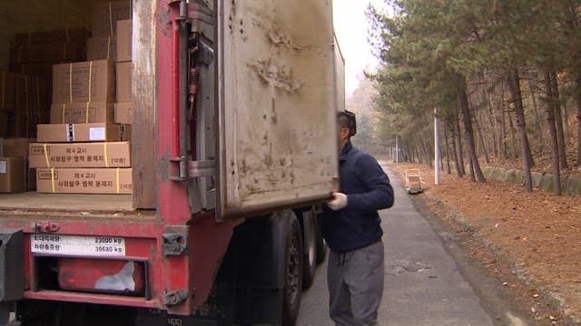 Man Loading Boxes onto a Delivery Truck