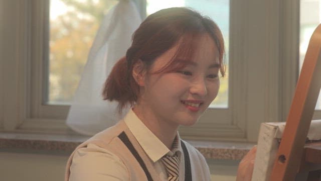 Student drawing in a classroom