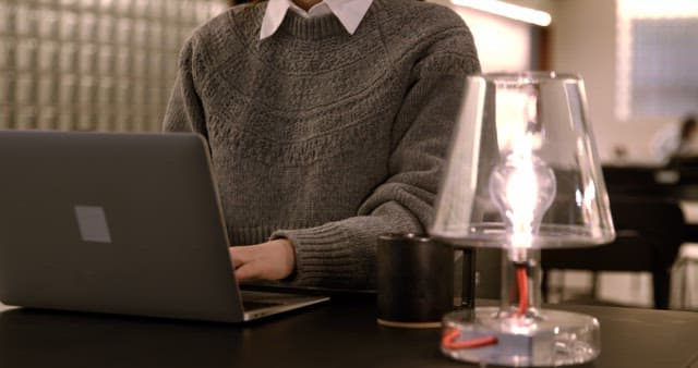Person Studying with Laptop at Cafe Table