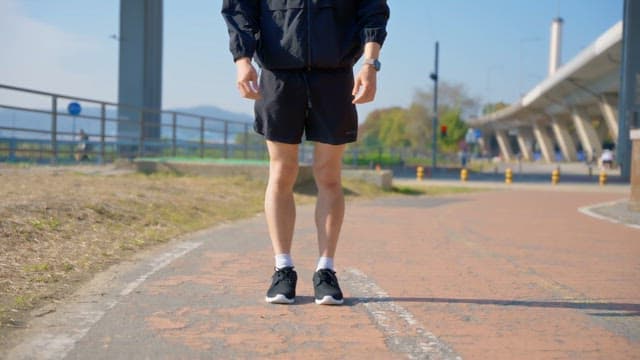 Man preparing to run on a sunny day