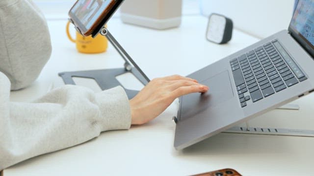 Person working on a laptop at a modern desk