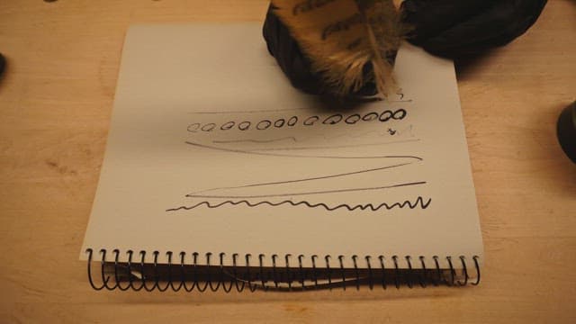 Person doodling in a sketchbook