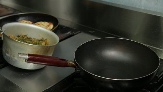 Cooking vegetables and fermented kimchi in a frying pan