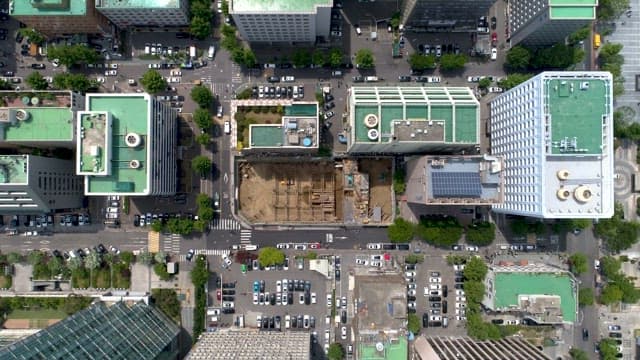 Cars on the Road Between Buildings